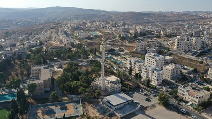 Naklejka premium Golden Mosque Tower Minaret in Beit Hanina, Aerial view Palestinian Muslim Mosque Masjed aldaoa, Drone image 
