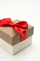Gift box with red ribbon on white background.