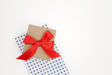 Gift box with red ribbon on white background.