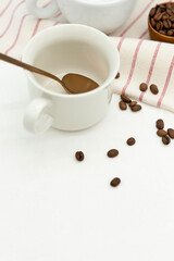 Coffee beans and cup on a table.