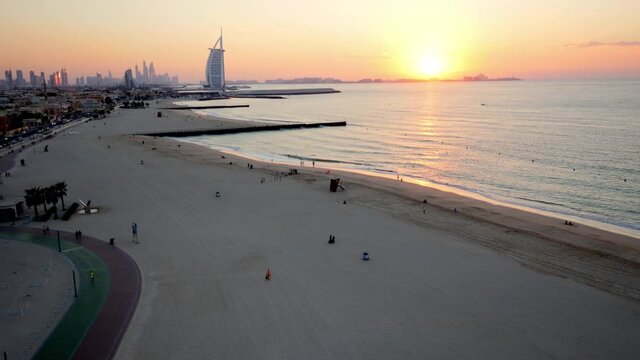 Amazing aribian sunset of the kite beach along the coast line of the Dubai, 6- axis stabilized gimbal, Shotover F1, 8K, parallax.