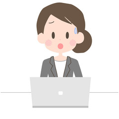 困った表情でノートパソコンを操作するビジネスウーマン