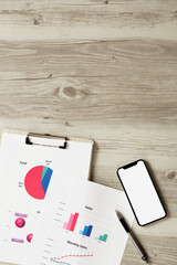 Business documents and a smartphone on the table or desk. テーブルまたはデスクの上のビジネス資料とスマホ