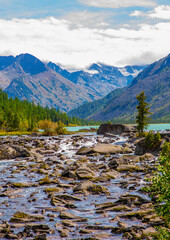 Fototapeta na wymiar View of the snowy peaks from the noises of the second multinsky lake in the mountains of Altai
