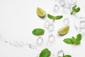 Ice cubes, lime and mint on light background