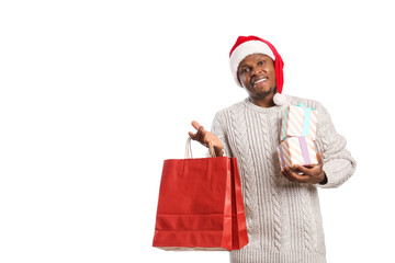 African-American man in Santa hat, with shopping bags and gifts on white background