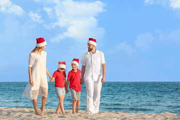 Happy family celebrating Christmas at tropical resort