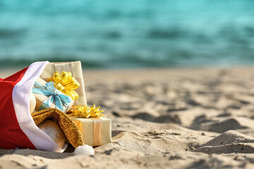 Santa Claus bag with gifts on beach © Pixel-Shot