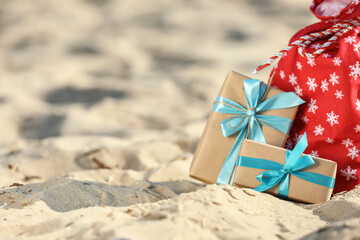 Santa Claus bag with gifts on beach