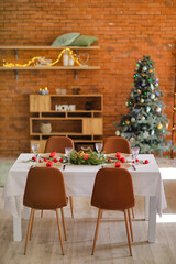 Interior of room with table set for Christmas dinner