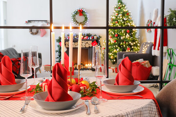 Beautiful table setting with Christmas decor in living room