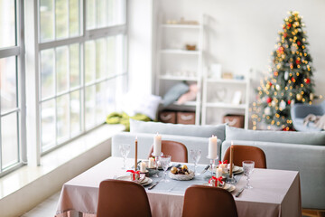 Interior of room with table set for Christmas dinner