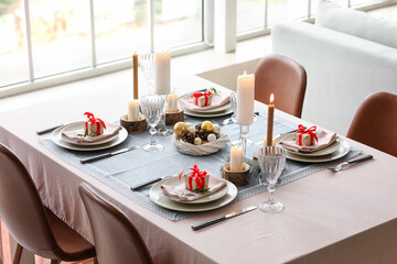Beautiful table setting with Christmas decor in living room