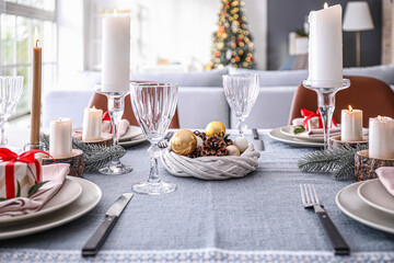 Beautiful table setting with Christmas decor in living room
