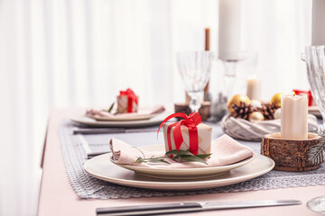 Beautiful table setting with Christmas decor in living room