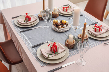 Beautiful table setting with Christmas decor in living room