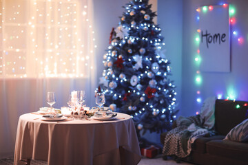 Interior of room with table set for Christmas dinner