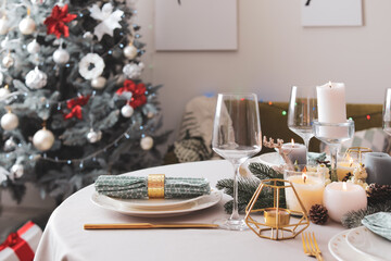 Beautiful table setting with Christmas decor in living room