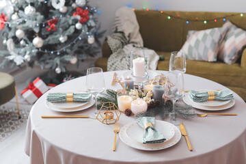 Beautiful table setting with Christmas decor in living room