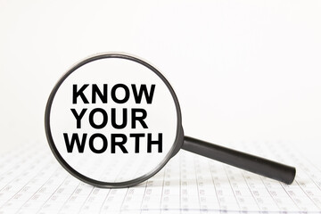 text KNOW YOUR WORTH in a magnifying glass, office concept, business concept, Finance