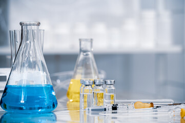 Various tools and containers used in experiments. Vaccine development concept.