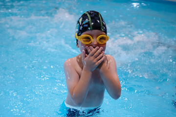 little boy swimming in the pool.Swimming lessons for little ones