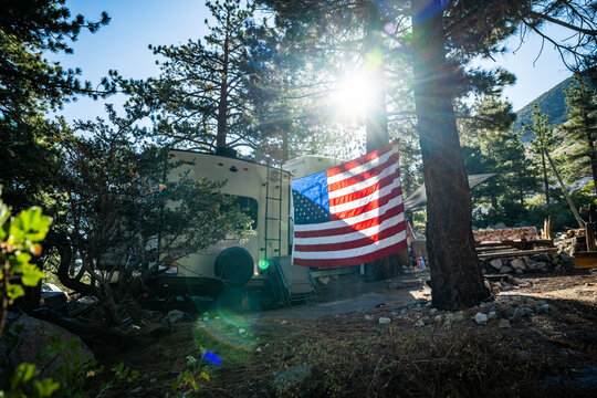 American flag backlit in RV campground wide shot
