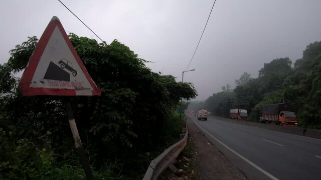 Traffic sign shows steep slope ahead thane nantional highway ghodbunder road.