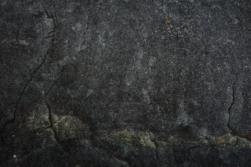 Dark gray stone texture. Industrial design background. Abstract grunge. Old rough black granite surface. Image with copy space.
