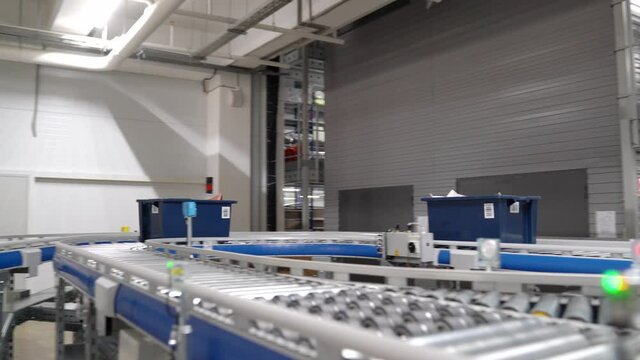 conveyor belt with boxes in warehouse of online store. system for picking orders