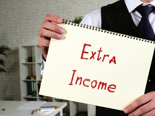 Financial concept meaning Extra Income with sign on the piece of paper.