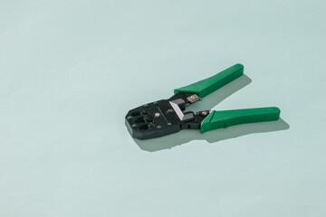 Creamer with green handles on a light blue background.