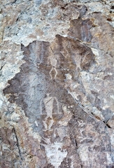 Ancient rock paintings with warriors, shamans and deer on the white marble steep wall of Cape Sagan-Zaba on the shore of the Siberian Baikal Lake