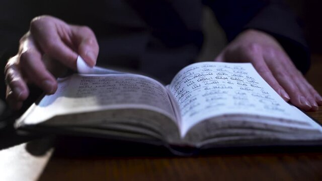 A Jew prays, turns a page in a prayer book, Close up hands,