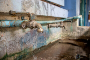 old faucet with water drop, water consumption concept, hydrant close-up, old faucet water or valve...