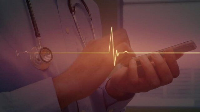 Red glowing heart rate monitor against mid section of male doctor using smartphone