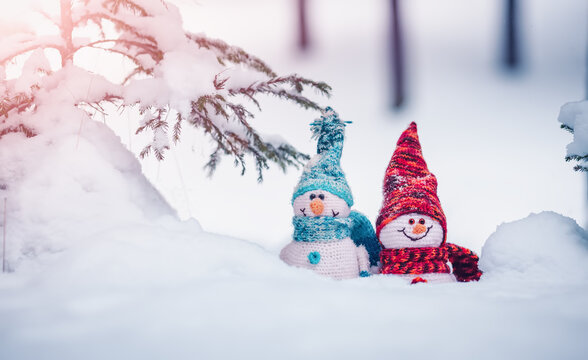 little snowmans on soft snow on blue background