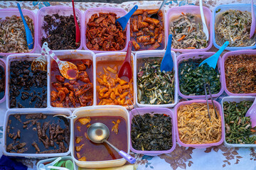 Variety of delicious Malaysian home cooked dishes sold at street market stall in Kota Kinabalu, island Borneo, Malaysia