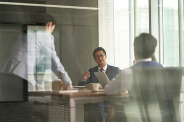 asian corporate executives meeting in conference room