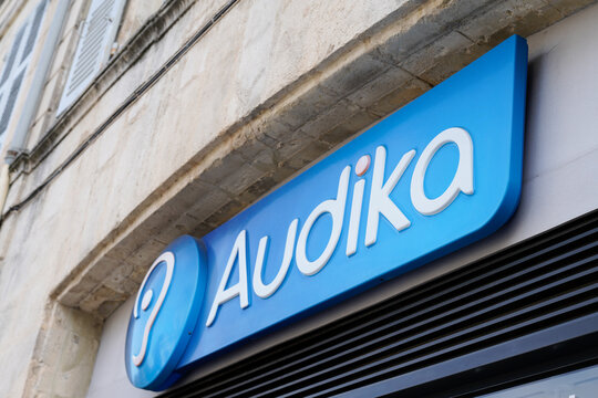 Audika logo and text sign front of medical store hearing aid distribution shop company