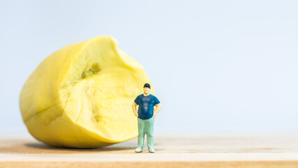 Miniature people : Close up fat man standing with durian isolated on white background 