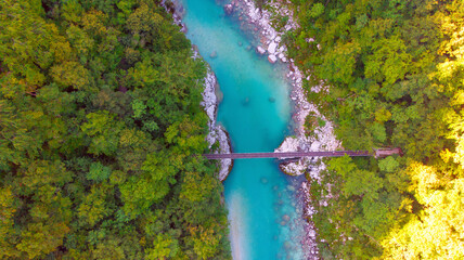Aerial view of the turquoise blue Soca river (Isonzo) and wooden bridge near Bovec in the Julian Alps