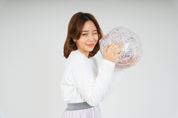Young asian woman with glitter plastic ball isolate on white background.