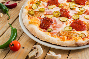 tasty pizza on the wooden background
