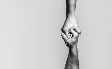 Two hands, helping arm of a friend, teamwork. Helping hand concept and international day of peace, support. Black and white - obrazy, fototapety, plakaty