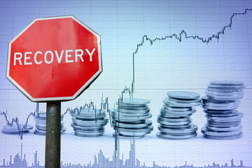 Recovery stop sign against economic background with graph and coins. Recovery from economic crisis.