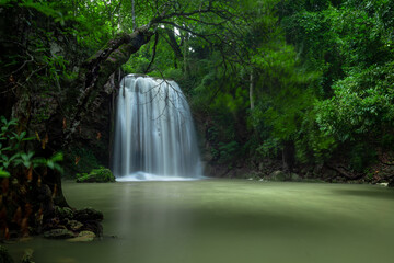 A beautiful waterfall deep in the tropical forest, steep mountain adventure in the rainforest.