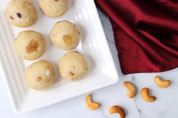  Rawa Ladu, Rava coconut Laddu or Semolina balls. It's a sweet dish from Maharashtra, India. Made using semolina, coconut & sugar. Its famous for festivals like, Diwali, Dussehra, Navratri. copy space