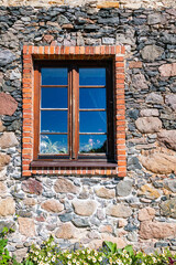 Fototapeta na wymiar stone masonry wall with wooden window