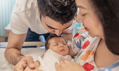 Obraz premium Closeup portrait of young asian Indian father holding his newborn baby with copy space. Healthcare and medical daycare nursery love lifestyle together single dad father’s day holiday concept